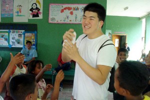 Brian Yu '13 (BUS) plays with the kids at an orphanage in Honduras before setting up triage as a part of their medical clinic, where they taught patients how to take care of their teeth and floss.