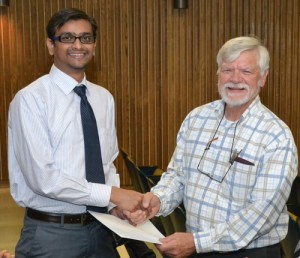 Postdoctoral student Aniket Jadhav (left) accepts an Auxiliary scholarship from Dr. Art Hand. (Chris DeFrancesco/UConn Health Center Photo)