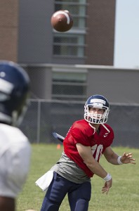 Quarterback Chandler Whitmer '14 (CLAS) throws some warm-up passes to Geremy Davis '15 during the UConn football team's open practice on Aug. 7. (Peter Morenus/UConn Photo)