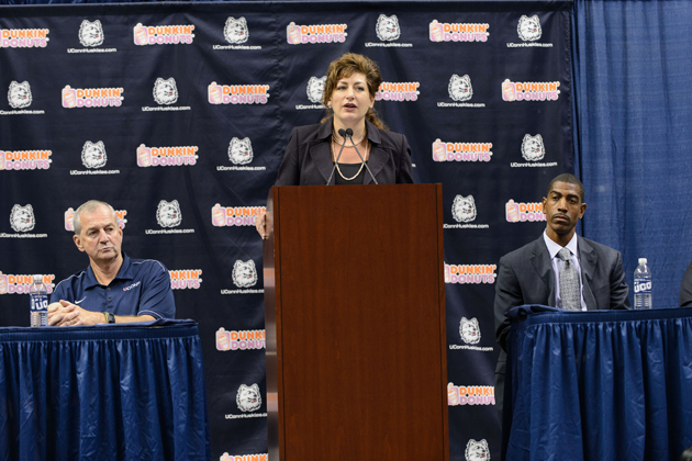President Susan Herbst, center, speaks at a press conference in Gampel Pavilion to announce the retirement of Jim Calhoun, left, and the appointment of Kevin Ollie, right, as head men's basketball coach on Sept. 13. (Peter Morenus/UConn Photo)
