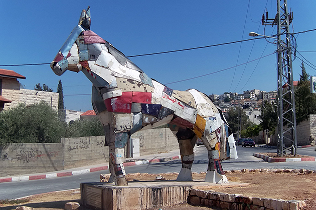 A sculpture in front of the Freedom Theatre in the Jenin Refugee Camp in Occupied Palestine was built by a German artist from blown up car parts from the Second Intifada. (Photo courtesy of Gary English)
