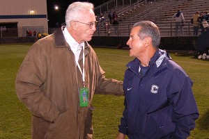 Former Huskies men's basketball coach Dee Rowe congratulates head coach Len Tsantiris '77 (ED) on earning his 500th career win after the women's soccer team defeated Rutgers 3-1 in the first round of the Big East Tournament on Thursday. (Ken Best)