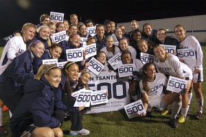 The women's soccer team celebrate the 500th career win of head coach Len Tsantiris at Morrone Stadium on Thursday, after the Huskies defeated Rutgers 3-1 in a first round game in the Big East Tournament. (Ken Best/UConn Photo)
