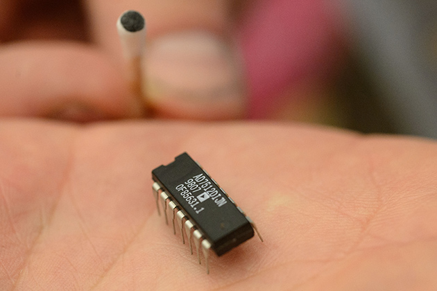 A counterfeit integrated circuit and a cotton swab showing paint removed from the fraudulent label. (Peter Morenus/UConn Photo)