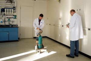 David Bourret and Robert Lawson of Research Safety check an emptied laboratory for radiation before construction begins. (Tina Encarnacion/UConn Health Center Photo)