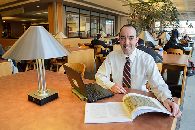 Brendan Kane, associate professor of history and associate director of the Humanities Institute, in the reading room of the Homer Babbidge Library. (Ariel Dowski '14 (CLAS)/UConn Photo)