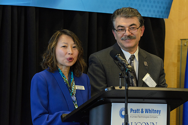 Agnes Klucha, program manager at Pratt &amp; Whitney, and Kazem Kazerounian, interim dean of the School of Engineering, speak at the April 5 event. Pratt &amp; Whitney engineers and UConn faculty and students will work together at the new center. (Ariel Dowski '14 (CLAS)/UConn Photo)