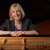 Brid Grant, dean of fine arts, sits at a Steinway grand piano on the stage of von der Mehden Recital Hall on April 2, 2013. (Peter Morenus/UConn Photo)