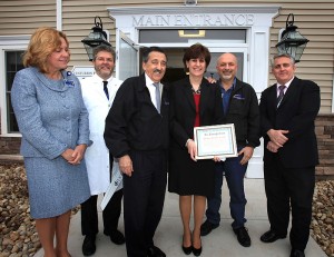 During the Open House, the Health Center was awarded a 2013 Beautification Award from the Southington Chamber of Commerce.  (left to right) Amanda Hopkins-Tirrell, Denis Lafreniere, Art Secundo from the Southington Chamber of Commerce, Anne Horbatuck, Charlie Cocuzza from the Southington Chamber of Commerce and Gus Mazzocca on April 11, 2013. (Michael Fiedler/UConn Health Center Photo)