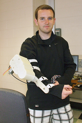 Brian Coleman'13 (ENG) developed a robotic arm that can be used by astronauts to prevent muscle loss in zero gravity. (Cathleen Torrisi/UConn photo)
