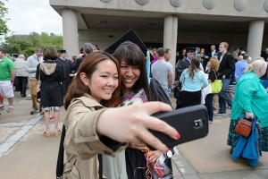 Michelle Lieu, right, poses for a photo with her friend Chun Yu of Newington following the Neag School of Education commencement ceremony at the Jorgensen Center for the Performing Arts on May 12, 2013. (Peter Morenus/UConn Photo)