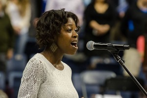 Shaelle Etienne '14 signs the national anthem at the School of Business Commencement ceremony held at Gampel Pavilion on May 12, 2013. (Ariel Dowski '14 (CLAS)/UConn Photo)