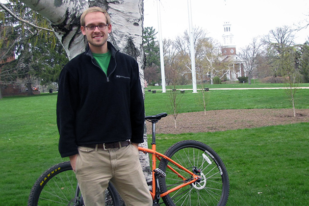 Mark Smith '13 MS Geoscience major and Innovation Quest award winner stands with his bicycle outside Beach Hall on April 29, 2013. (Sheila Foran/UConn Photo)