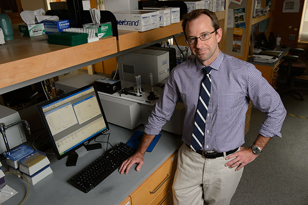 Nathan Alder, assistant professor of molecular and cell biology at his lab on June 27, 2013. (Peter Morenus/UConn Photo)