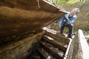 Stuart Miller, professor of hebrew, history and Judaic studies points to the spot at which water would enter a former mikvah in Old Chesterfield.. (Peter Morenus/UConn Photo)