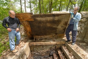 Nicholas Bellantoni, state archeologist, left, Stuart Miller, professor of hebrew, history and Judaic studies look down into the site of a former mikvah. (Peter Morenus/UConn Photo)