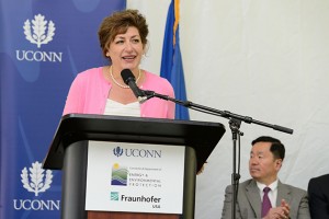 President Susan Herbst speaks at an event held at the University of Connecticut Depot Campus to mark the Inauguration of the Fraunhofer Center for Energy Innovation (CEI) at UConn on July 25, 2013. Seated at right is Provost Mun Choi. (Peter Morenus/UConn Photo)