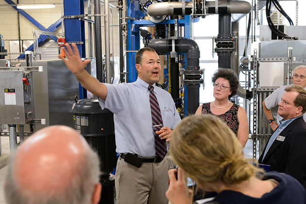 Ron Gaudet, director of utilities, leads a tour of the plant during an event to celebrate the opening of the Water Reclamation Facility on July 10, 2013. (Peter Morenus/UConn Photo)