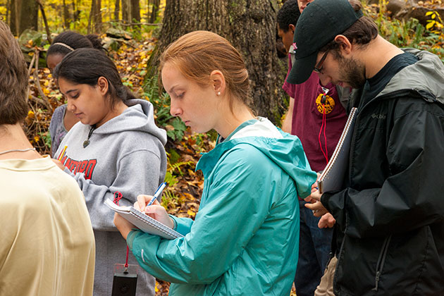 Hannah Gousse ’14 takes field notes during an ecology class taught by Jenica Allen, assistant professor-in-residence. (Sean Flynn/UConn Photo)