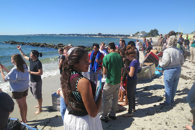 Students, faculty, and staff gather on the beach to watch the cardboard boat race on Sept. 19, 2013. (Nat Trumbull/UConn Photo)