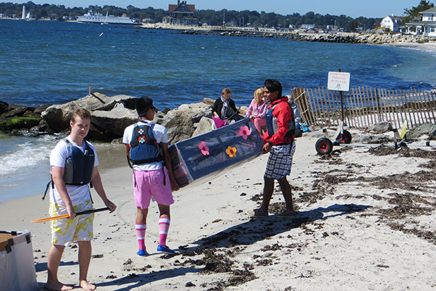 Student contestants carry their boat to the water's edge before the race. (Noreen Blaschik/UConn Photo)