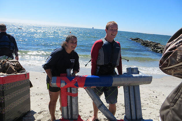 Maritime studies major Lauren Barber '15 (CLAS), left, and marine sciences major Tim Bateman '16 (CLAS) with their craft. (Noreen Blaschik/UConn Photo)