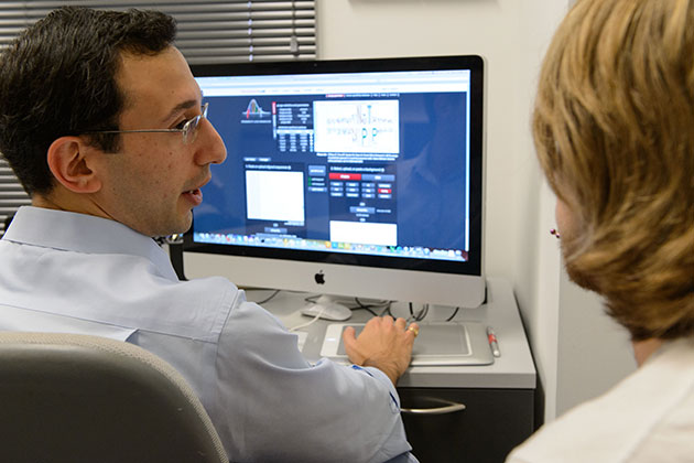 Daniel Schwartz, assistant professor of physiology and neurobiology, discusses the new software with Joey Shea '14 (ENG). (Peter Morenus/UConn Photo)