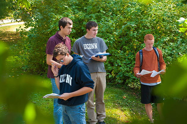 From left, Tim Lucas ’17, Matt Kren ’17, Tyler McCutcheon ’16, and Donovan Fifield. An outdoor geography class introducing the environmental processes and patterns, especially assessing change in environmental systems using spatial analysis techniques. (Sean Flynn/UConn Photo)