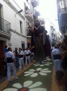 P10-foot-tall puppets dance through the streets on a carpet of flowers in Sitges, Spain.