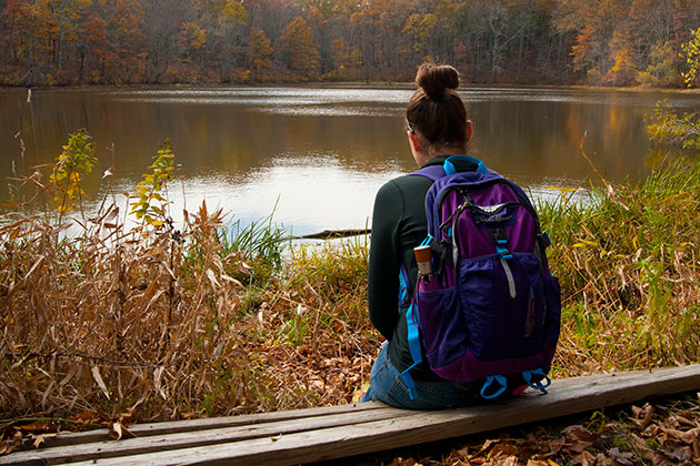 Megan Gauer '16 participates in silent reflection during a field trip to Tift Pond. (Sean Flynn/UConn Photo)