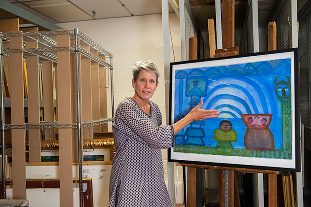 Kathryn Myers discusses one of the works of art that will be on display in the exhibition 'Convergence: Contemporary Art from India and the Diaspora,' which opens at the Benton Museum on Oct. 22. (Sean Flynn/UConn Photo)