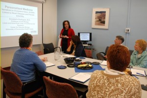 Dr. Annabelle Rodriguez discusses her research into the link between heart disease and female infertility with legislative leaders and Dr. Frank Torti. (Janine Gelineau/UConn Health Center Photo)