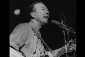 Pete Seeger performs at a 1965 peace rally in New York City. (Photo by Diana Davies, courtesy of Smithsonian Folkways)