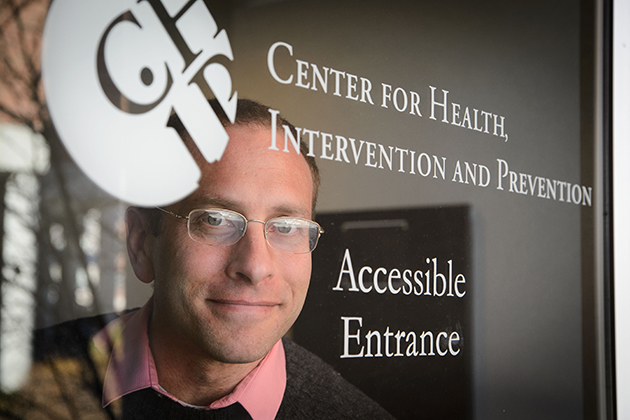 Ph.D. candidate David Finitsis, an affiliate of CHIP, is conducted a meta-analysis that identified the health benefits of text messaging between providers and patients. (Peter Morenus/UConn Photo)