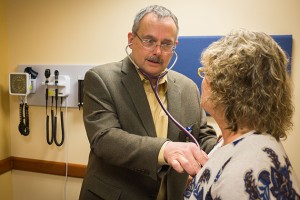 Craig Ryan MD meets with a patient at UConn Health Urgent Care at Storrs Center. (Peter Morenus/UConn Photo)