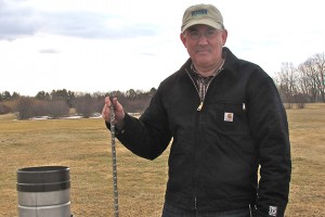 Farm manager Steve Olsen measures snow the old fashioned way – with a ruler. (Sheila Foran/UConn Photo)