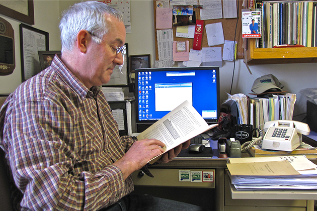 Steve Olsen '85 (CANR) has both electronic data and historic paper records available for reference in his office. (Sheila Foran/UConn Photo)