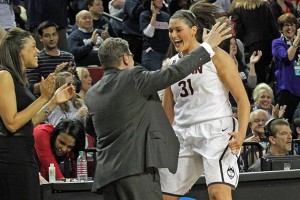 Head Coach Geno Auriemma congratulates Stefanie Dolson as she leaves the court with a minute left in the game. (Bob Stowell for UConn)