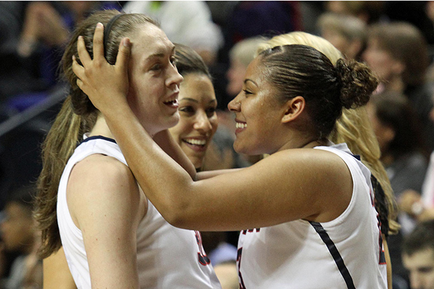 Kaleena Mosqueda-Lewis '15 (CLAS), right, congratulates teammate Breanna Stewart '16 (CLAS). Stewart was the leading scorer, with 21 points. (Bob Stowell '70 (CLAS)