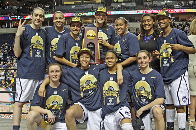 The women's basketball team with the NCAA National Championship trophy, the ninth time the team has won the title. The Huskies beat Notre Dame 79-58. (Bob Stowell '70 (CLAS) for UConn)