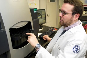 Ph.D. Candidate David Drew uses a laser capture microdissection instrument to isolate aberrant colon cells to investigate the earliest initiating events leading to colon cancer. March 6, 2014. (Tina Encarnacion/UConn Health Photo)