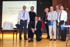 Dr. David Henderson (kneeling) and Christine Thatcher (fourth from right) pose with First-Year Teaching Award recipients. From left Richard Zeff; Dr. Srdjan Antic; Yvonne Grimm Jorgenson; John Harrison, James Watras, and Dr. Thomas Manger. (Photo provided by Roselyn Wright)