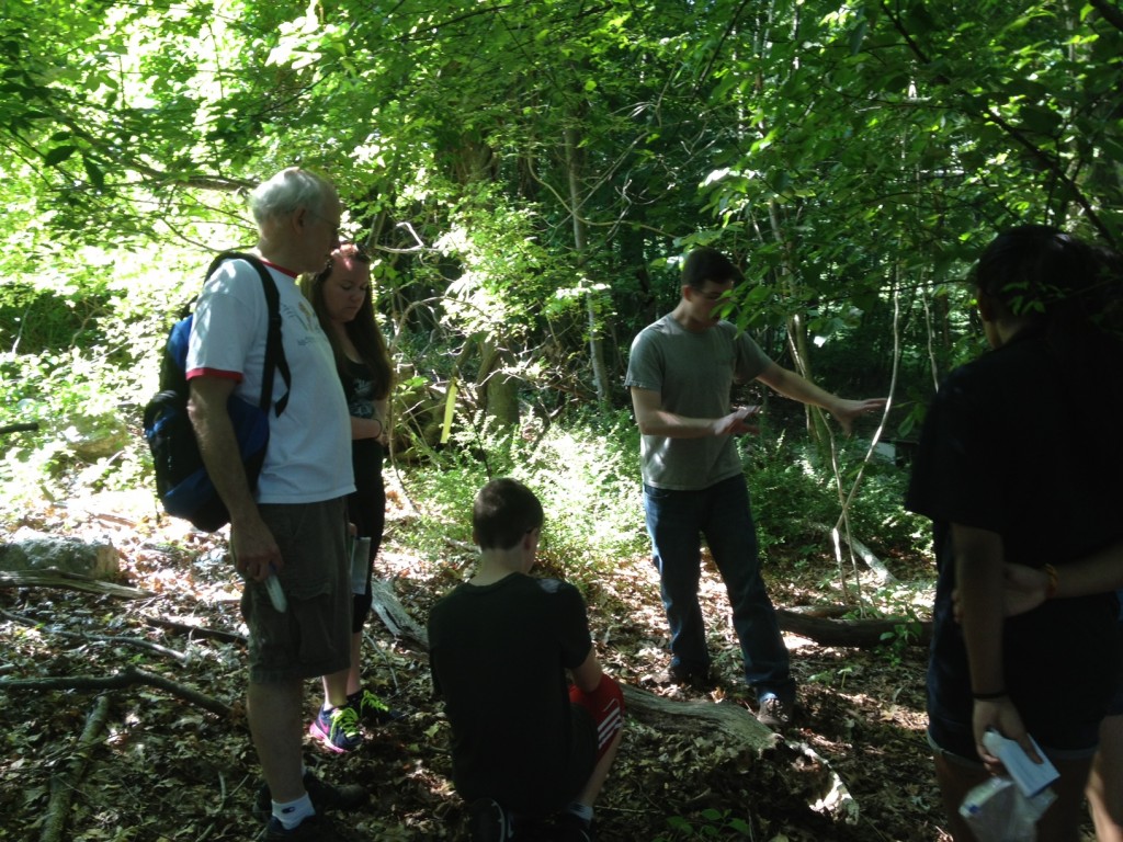 Dr. Kenneth Noll with microbiology Ph.D. students Jamie Micciulla and Charles Bridges, lead KASET participants on a search for termites on the UConn campus. Termites are full of microbes that enable them to break down wood and produce energy. (David Colberg/UConn Photo)