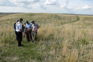 Mark Lindvall (left) of the Valentine National Wildlife Refuge identified prairie plants during a walk at the refuge. The refuge leases grassland to the Rocking Arrow Ranch in Nebraska for their cattle to graze. (Photo courtesy of Tom Morris)