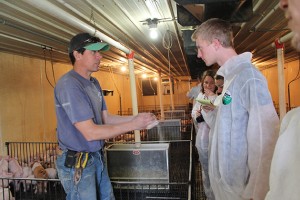 At the 1,500-acre Friest grain and hog farm in Radcliffe, Iowa, students asked questions and took notes on the role of large scale agricultural production. (Photo courtesy of Tom Morris)