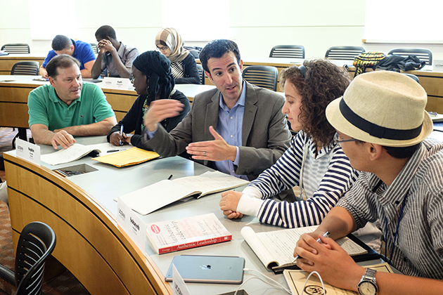 Roy Pietro, director of UConn’s Global Training and Development Institute (left), and Chad Turner, co-founder of Go Media (center), speak to students from North and Sub-Saharan Africa at a workshop on using the Internet. The students, from left to right, are Sofie Camara (Senegal), Rafika Mokhtari (Algeria), and Sohayeb Belguith (Tunisia). (Peter Morenus/UConn Photo)