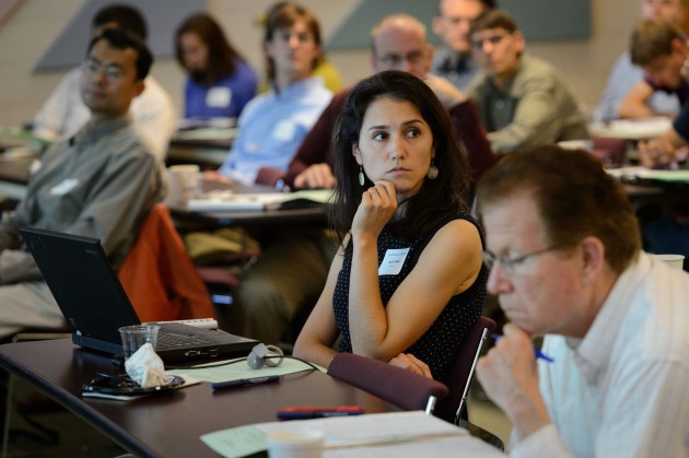 Ariel Lambe, assistant professor of history, listens to a presentation during the new faculty orientation held at the Rowe Center on Aug. 20-21. (Peter Morenus/UConn Photo)