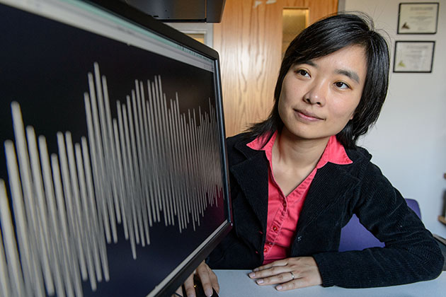 Xinnian Chen, assistant professor-in-residence in physiology and neurobiology, looks at a graph showing the respiration pattern of an infant. (Peter Morenus/UConn Photo)