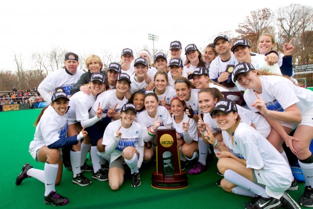 The UConn field hockey team and head coach Nancy Stevens (back row, second from left) pose with the 2014 NCAA National Championship trophy, after defeating Syracuse 1-0 to win the tournament. (Keith Lucas, Sideline Media, for UConn)