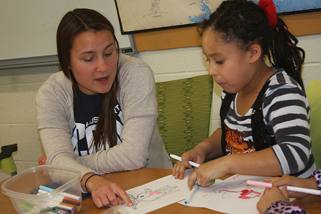 The Husky Sport program brings groups of UConn students to Clark School to engage in sports with students, and build friendships that, in time, allow them to talk about nutrition, healthy lifestyles, and life skills, and provide academic support. (Neag School of Education/UConn File Photo)